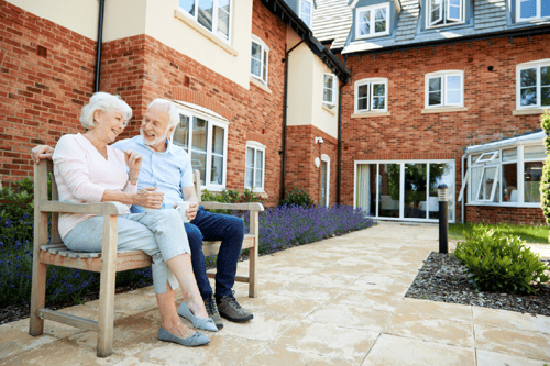 image_elderly-couple-seated-in-courtyard-of-retirement-community