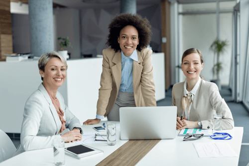image_team-of-businesswomen-working-in-office-smiling-at-camera