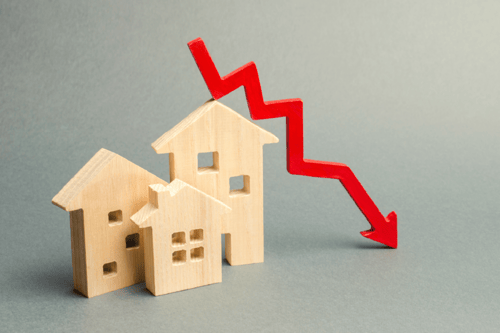 image_three-small-wooden-houses-with-red-arrow-going-down